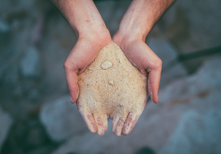 hands full of glass sand